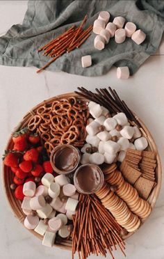 a plate filled with snacks and marshmallows