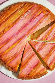 there is a pie that has been cut into slices and placed on a plate with pink table cloth