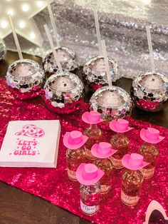 the table is set up with pink and silver confetti