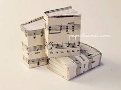 stack of sheet music notes sitting on top of each other in front of a white background