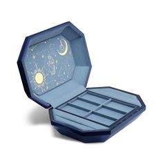 an open blue box with stars and moon designs on the inside, sitting on a white surface