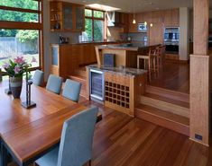 an open kitchen and dining room with wood flooring