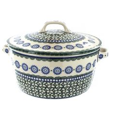 a blue and white casserole with ornate designs on the lid is sitting in front of a white background