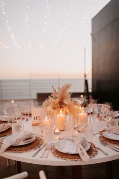 the table is set with candles and place settings