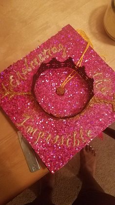 a pink graduation cap sitting on top of a table