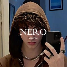 a woman wearing a brown hoodie is looking at her cell phone with the word nero on it