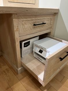 an open drawer on the side of a wooden cabinet