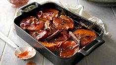 a pan filled with meat and vegetables on top of a table