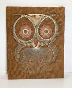 an owl made out of woven material sitting on top of a table