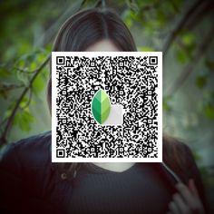 a woman is holding up a qr code to show the image on her face