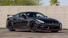 a black sports car parked in a parking lot