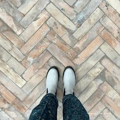 a person standing on top of a brick floor