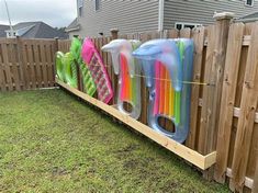 a wooden fence that has some fake toothbrushes on it