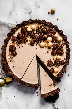 a cake with white frosting and chocolate sprinkles is cut into slices