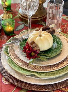 a table set for thanksgiving with plates and silverware