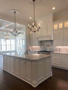 a large kitchen with an island and chandelier