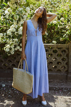 This Coralie Dress features a front tie detail and a plunging neckline, adding a dainty touch to this classic blue and white striped dress. Complete with pockets and a flowy skirt, this dress combines practicality with effortless style. Blue Sundress Outfit, Ingenue Essence, Sundress Outfit, Blue And White Striped Dress, Blue Sundress, Blue Cotton Dress, Savannah Wedding, White Striped Dress, Flowy Skirt