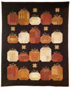 a quilted wall hanging with pumpkins and stars on the top one is black