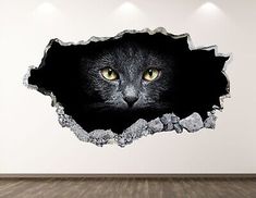 a black cat with yellow eyes peeking out of a hole in the wall that has been painted