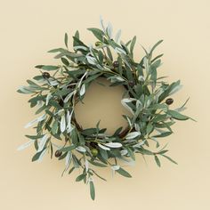 an olive wreath is hanging on the wall