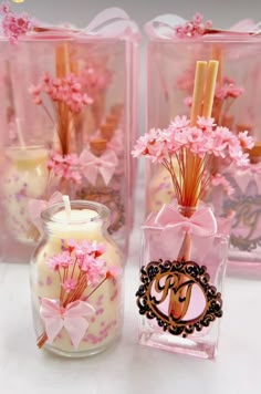 three vases with flowers and candles in them