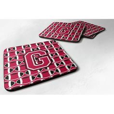 three coasters with the letter g on them