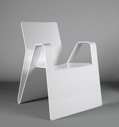 a white chair sitting on top of a gray floor