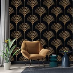 an art deco style wallpaper with gold and black designs on the walls, along with two chairs