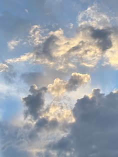 an airplane is flying in the sky with clouds