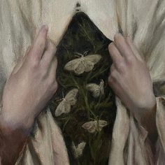 a painting of hands holding onto a piece of cloth with moths on it and green grass in the background