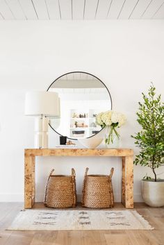 a table with baskets on it in front of a mirror