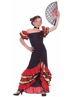 a woman in a black and red dress with a fan on her hand, posing for the camera