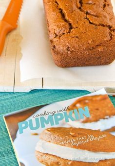 a magazine about pumpkin bread sitting on top of a table next to a loaf of cake