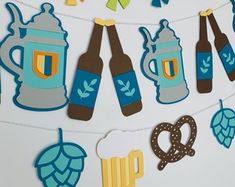 beer and pretzels cutouts are hanging on a clothesline with paper garlands