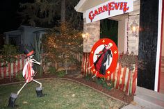 a halloween decoration in front of a carnival sign