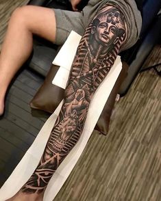 a man with a tattoo on his arm and leg