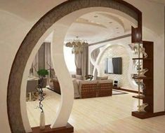 a living room filled with furniture and a large mirror in the middle of it's wall