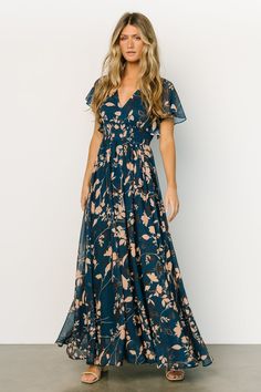 This gorgeous navy maxi gown is perfect for all seasons! The beautiful flow of the material and deep V neckline will have you feeling whimsical. V-neck Chiffon Maxi Dress With Print, Printed Chiffon V-neck Maxi Dress, Flowy Chiffon Dress With Floral Print And Short Sleeves, Chiffon Flutter Sleeve Dress For Brunch, Chiffon Dresses With Flutter Sleeves For Brunch, Chiffon Flutter Sleeve Brunch Dresses, Chiffon Maxi Dress With Floral Print And Surplice Neckline, Green Maxi Dress With Floral Print And Flutter Sleeves, Flowy Printed Dress With Flutter Sleeves