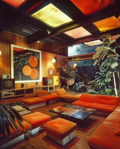 a living room filled with orange couches and tables