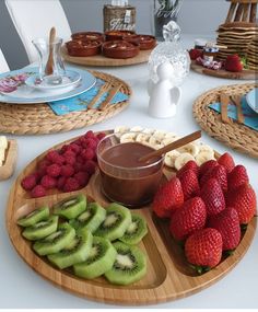 a plate with fruit, kiwis and other foods on it sitting on a table