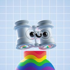 a pair of binoculars sitting on top of a rainbow ball in front of a tiled wall