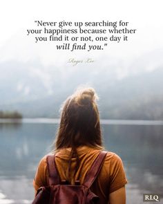 a woman with a backpack looking out at the water and quote about never give up searching for your happiness because it or not, one day it will find you