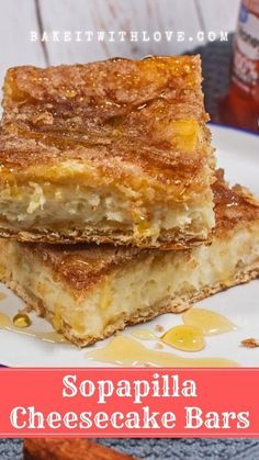 two pieces of cheesecake bars stacked on top of each other with honey syrup in the background