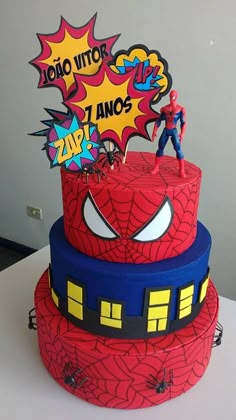 a spiderman birthday cake with the words hero written on it and an image of two people standing on top