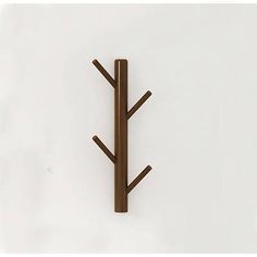 a wall mounted coat rack with three wooden trees on it's sides and two hooks in the middle