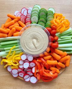 a platter filled with veggies and dip