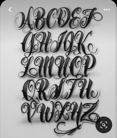 some type of lettering that looks like it is made out of black and white paper