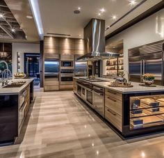 a large kitchen with stainless steel appliances and wooden cabinets