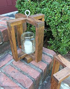 a candle holder sitting on top of a brick step