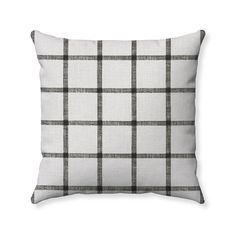 a black and white plaid pillow on a white background